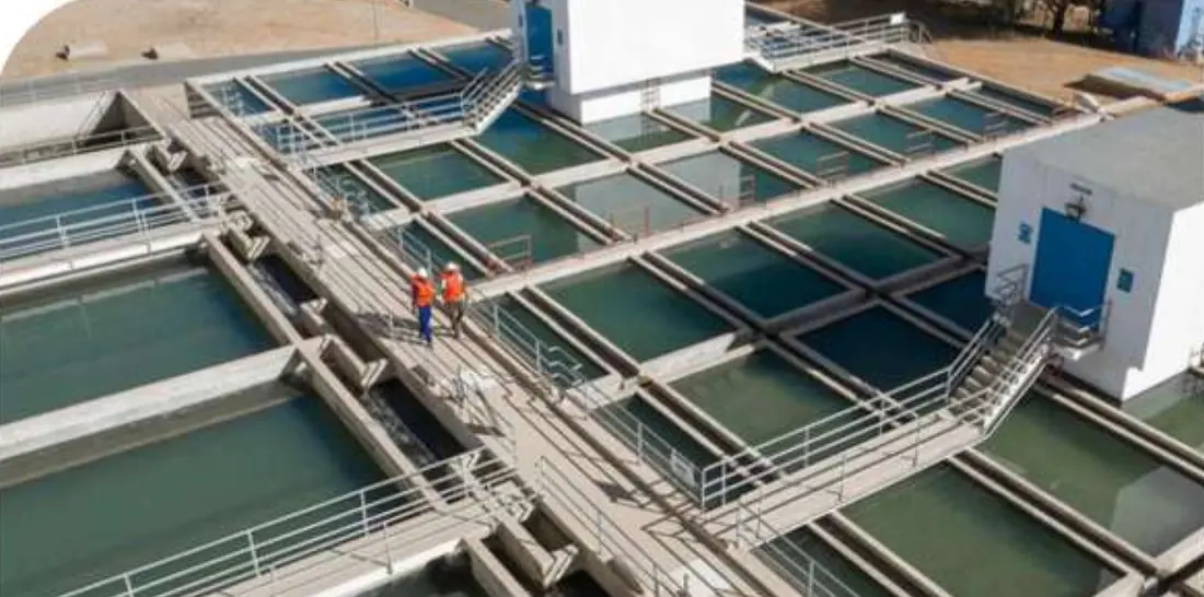 Aerial view of a water treatment works showing rectangular sedimentation and filter basins with walkways between them